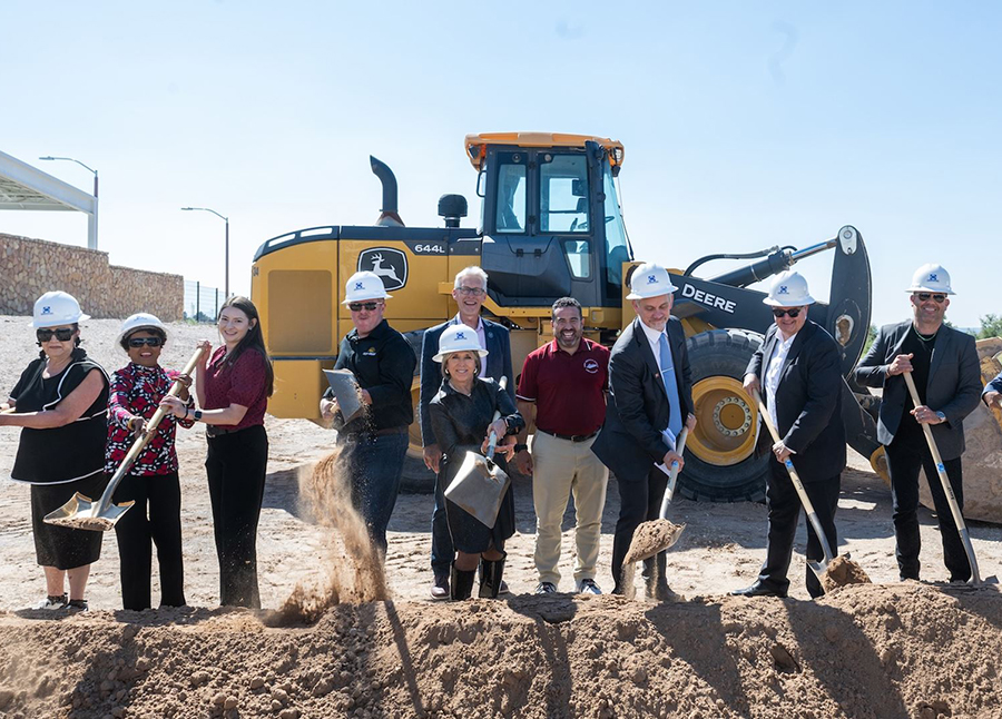 a group of people at a ground breaking with a shovel