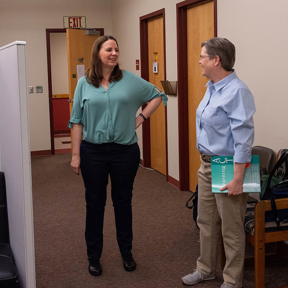 Two professors speaking in the Educational Psychology Department's Clinic.