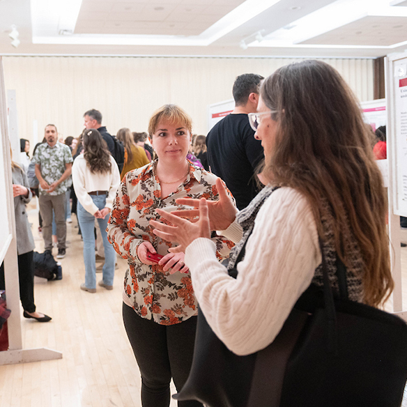 Two women discussing a poster project