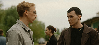 Two men having a conversation outside.