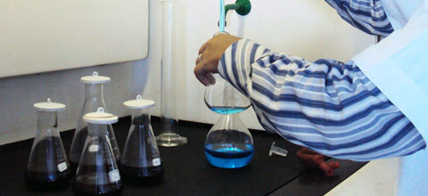 person using beakers