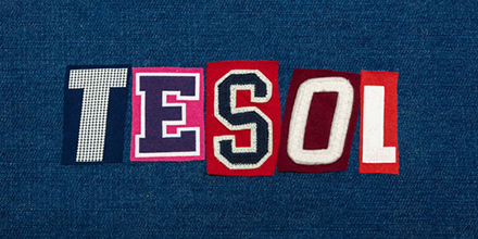 Chalkboard drawing of two children saying hello in Spanish and English