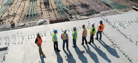 group of construction engineers looking at concrete
