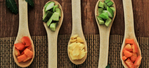 wooden spoons set out on a table for tasting vegetables