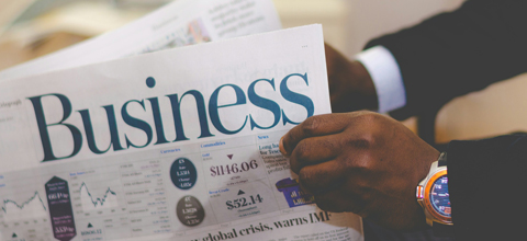 Businessman opening a paper