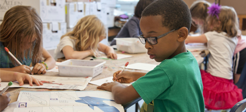 Students in classroom working on assignments.