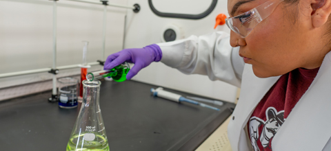 female student doing a chemical experiement